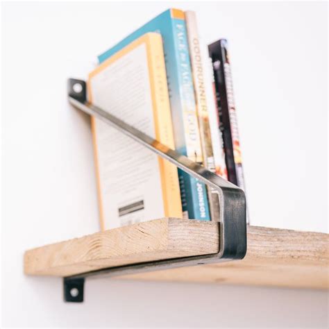 a creative bookshelf one metal bracket holding books|shelf bracket design ideas.